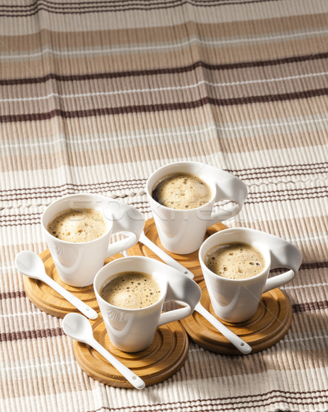 cups of coffee on place mats Stock photo © phbcz