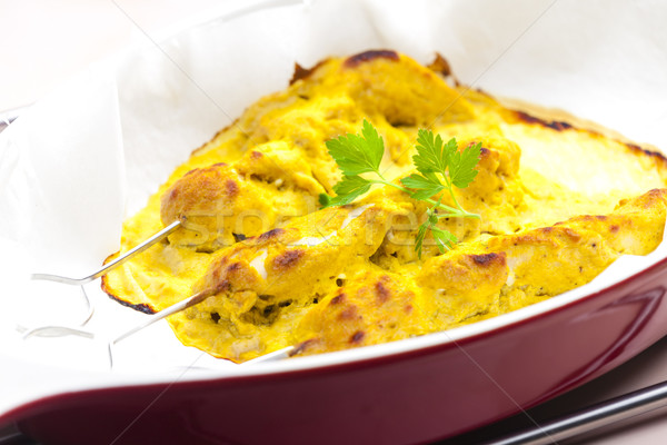 baked Indian curry chicken skewers in marinade Stock photo © phbcz