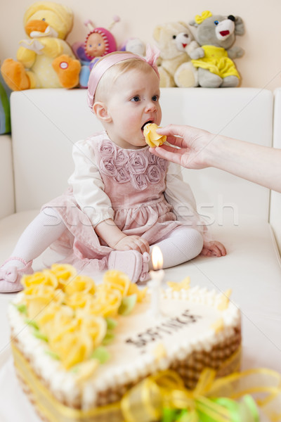 portrait of sitting toddler girl with her birthday cake Stock photo © phbcz