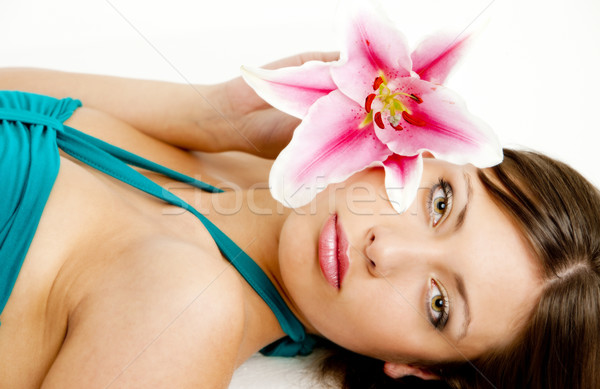 portrait of lying young woman with lily Stock photo © phbcz