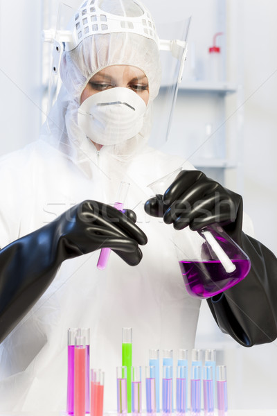 Stock photo: young woman wearing protective clothes in laboratory