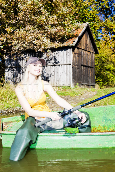 fishing woman sitting on boat Stock photo © phbcz