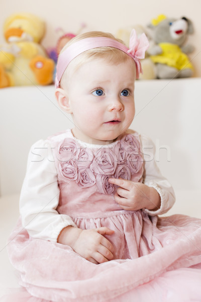portrait of sitting toddler girl wearing pink dress Stock photo © phbcz
