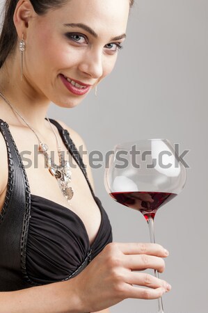 portrait of young woman with a glass of red wine and carafe Stock photo © phbcz