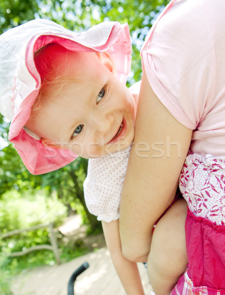 portrait of little girl hugging by her mother Stock photo © phbcz