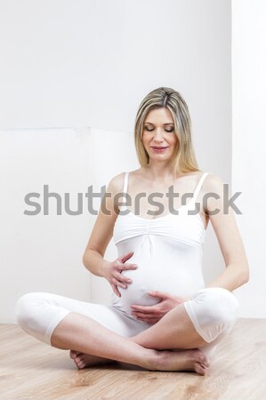 portrait of pregnant woman wearing lingerie with a tape measure Stock photo © phbcz