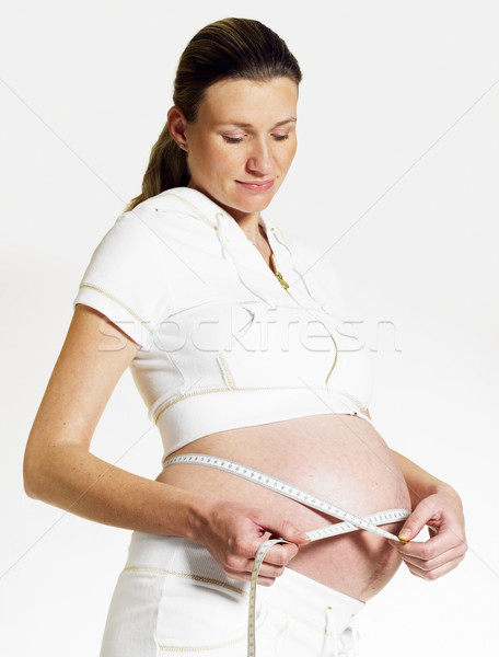 Kobieta centymetrem ciąży młodych sam kobiet Zdjęcia stock © phbcz