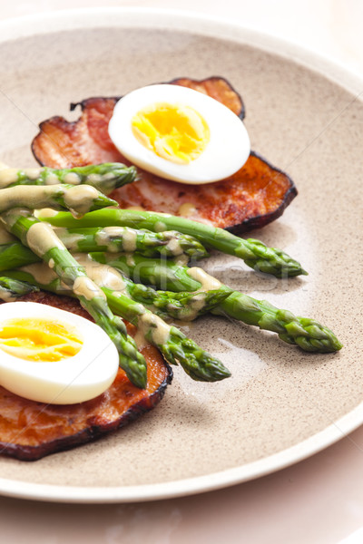 Stock photo: boiled green asparagus with bacon, egg and mustard dip