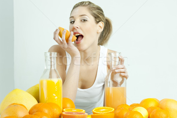 portrait of young woman with citrus fruit and orange juice Stock photo © phbcz