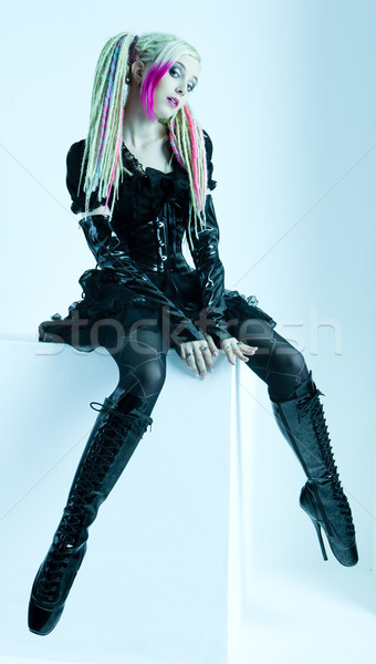 young woman with dreadlocks wearing extravagant clothes and boot Stock photo © phbcz