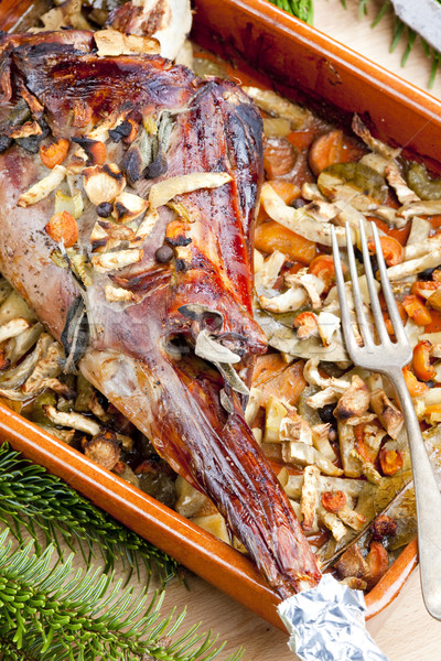 Stock photo: venison rump baked on vegetables with bay leaf and Jamaica peppe