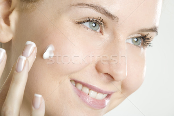 portrait of woman putting cream on face Stock photo © phbcz