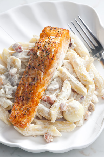 baked salmon on pepper with creamy pasta Stock photo © phbcz