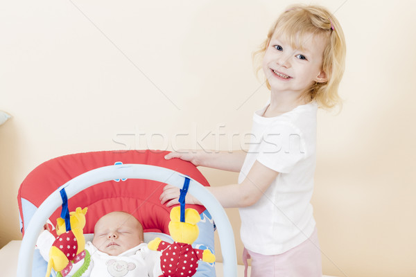portrait of a little girl with her baby sister sleeping in a cha Stock photo © phbcz