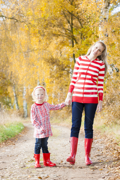 Stock photo: mother with her daughter in autumnal alley