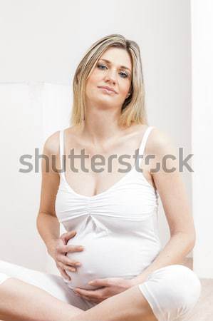 portrait of pregnant woman wearing lingerie with a tape measure Stock photo © phbcz