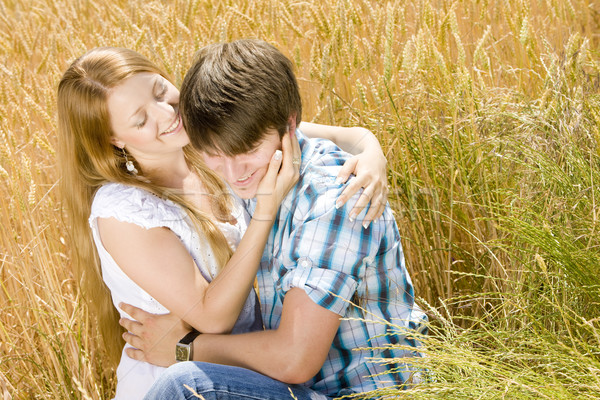 young couple sitting in grain field Stock photo © phbcz