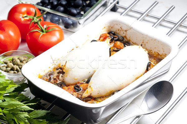 baked sepia with tomatoes and black olives filled with pearl bar Stock photo © phbcz