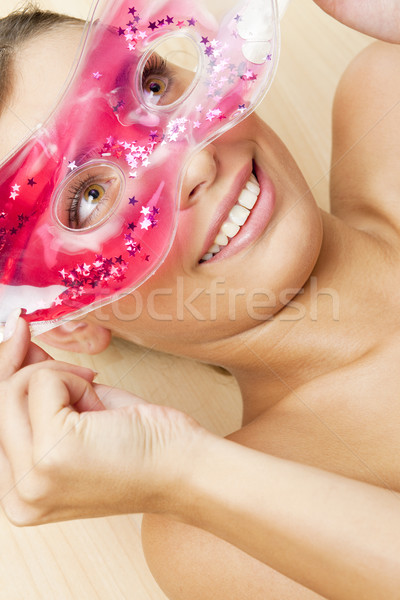 portrait of lying woman with cooling facial mask Stock photo © phbcz