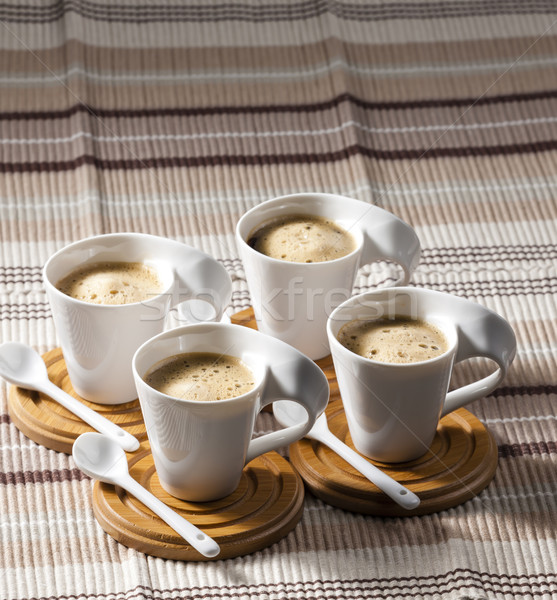 cups of coffee on place mats Stock photo © phbcz