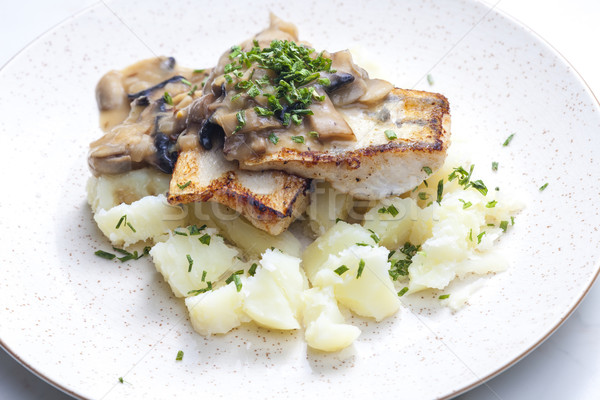 Stock photo: pikeperch on butter with mushroom sauce and spring potatoes
