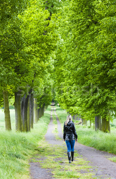 Mujer botas de goma caminando primavera callejón Foto stock © phbcz