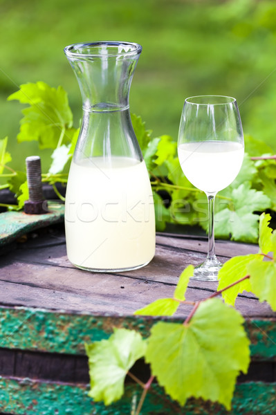 wine glass and carafe with wine cider standing on cask Stock photo © phbcz