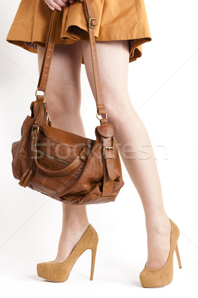 detail of standing woman wearing coat and brown pumps with a han Stock photo © phbcz