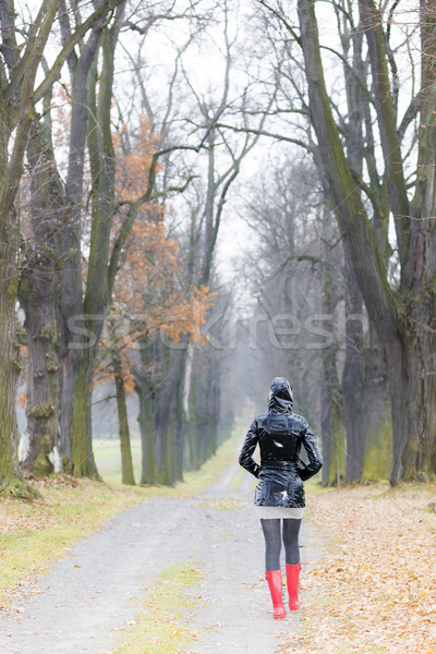 woman wearing rubber boots in autumnal alley Stock photo © phbcz