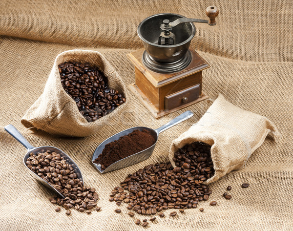 still life of coffee beans in jute bags with coffee grinder Stock photo © phbcz