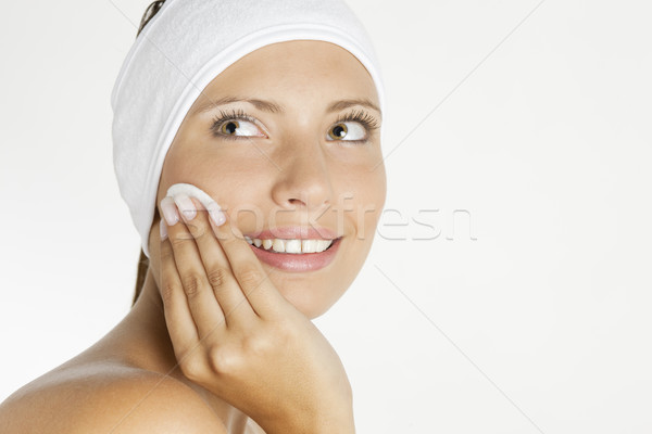 Stock photo: portrait of young woman wearing head dress with cotton pad