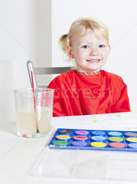 Stock photo: little girl painting with watercolors