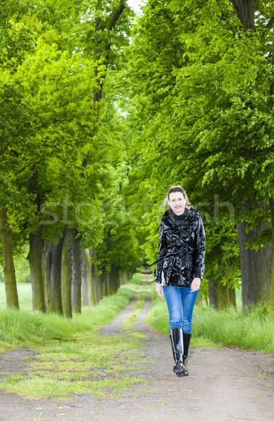 Mujer botas de goma caminando primavera callejón Foto stock © phbcz