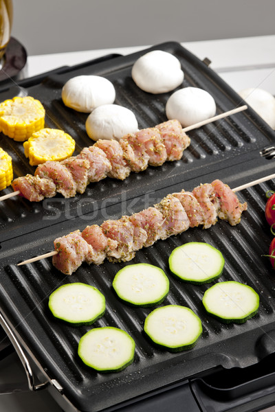 meat skewers and vegetables on electric grill Stock photo © phbcz
