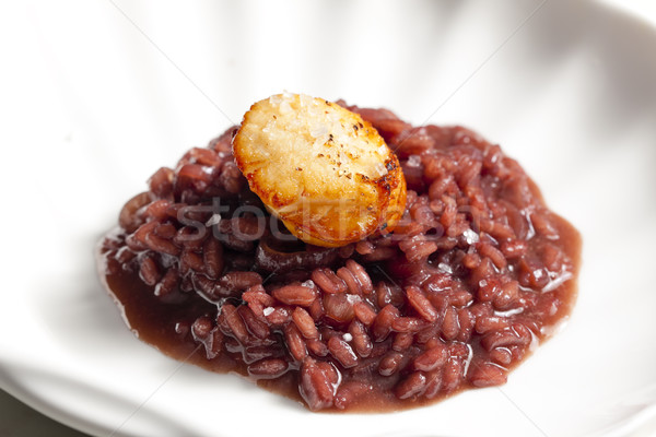 fried Saint Jacques mollusc on risotto steamed with red wine Stock photo © phbcz