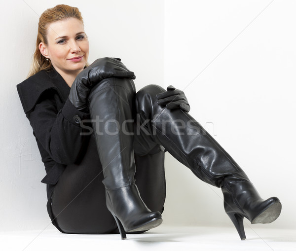 sitting woman wearing black clothes and boots Stock photo © phbcz