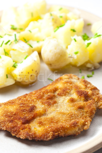 fried pork fillet with boiled unpeeled potatoes Stock photo © phbcz
