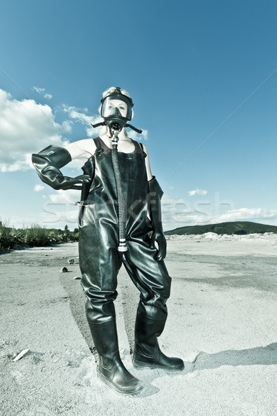 standing woman with gas mask wearing protective clothes Stock photo © phbcz