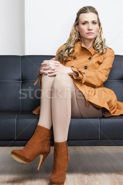 woman wearing brown coat sitting on sofa Stock photo © phbcz