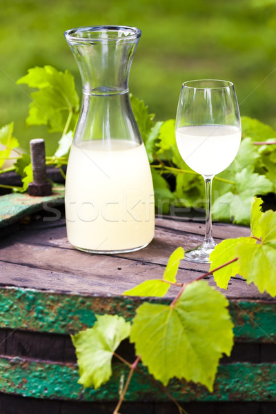 wine glass and carafe with wine cider standing on cask Stock photo © phbcz