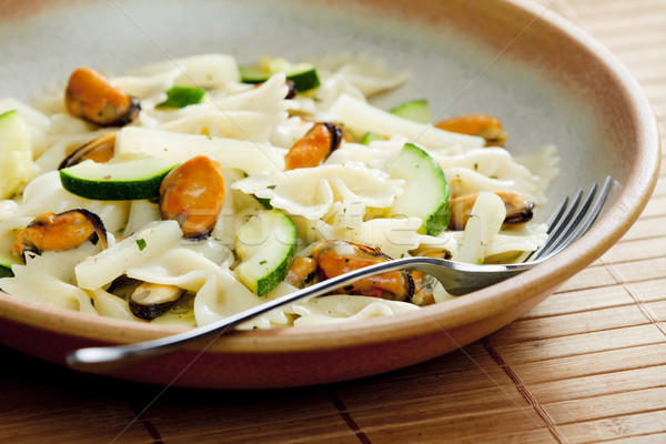 pasta farfalle with mussels and zucchini Stock photo © phbcz