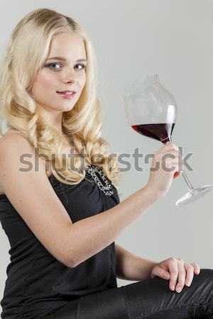 portrait of young woman with a glass of red wine and carafe Stock photo © phbcz