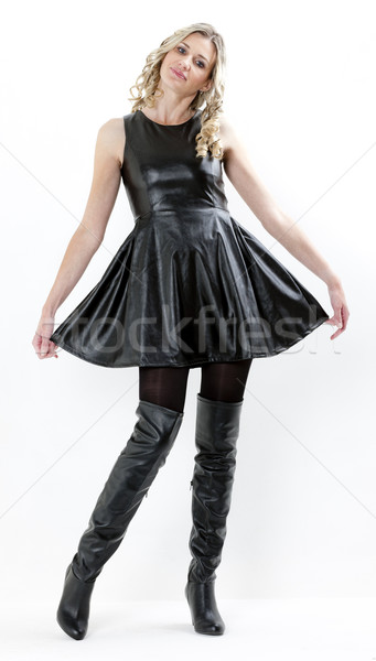 standing woman wearing black dress and black boots Stock photo © phbcz