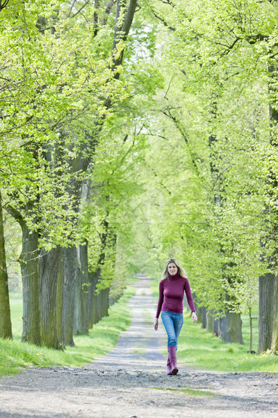 woman wearing rubber boots in spring alley Stock photo © phbcz