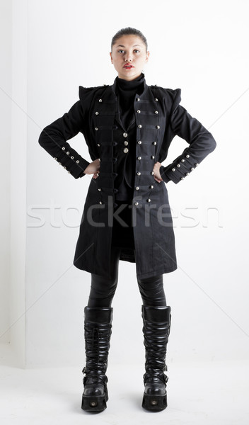 standing woman wearing extravagant clothes and boots Stock photo © phbcz