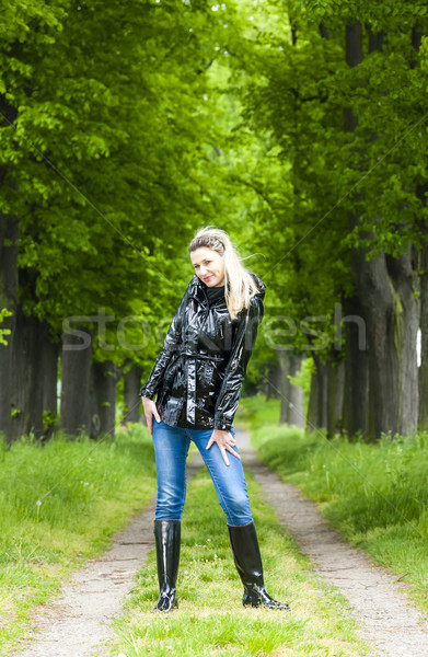 woman wearing rubber boots in spring alley Stock photo © phbcz