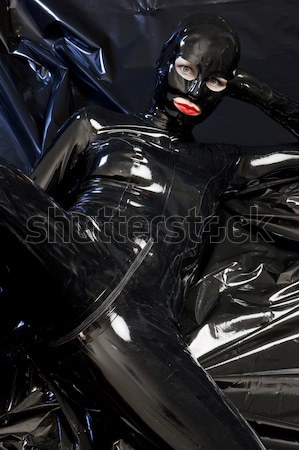 lying woman wearing latex clothes Stock photo © phbcz