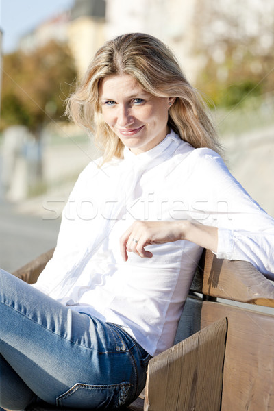 Stock photo: portrait of woman sitting on bench