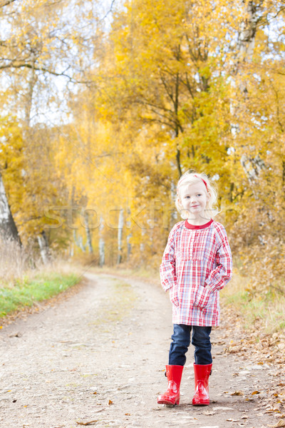 little girl wearing rubber boots in autumnal alley Stock photo © phbcz
