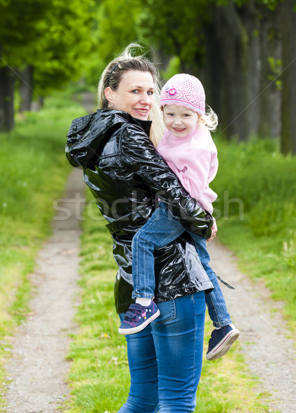 portrait of mother with her little daughter in spring alley Stock photo © phbcz